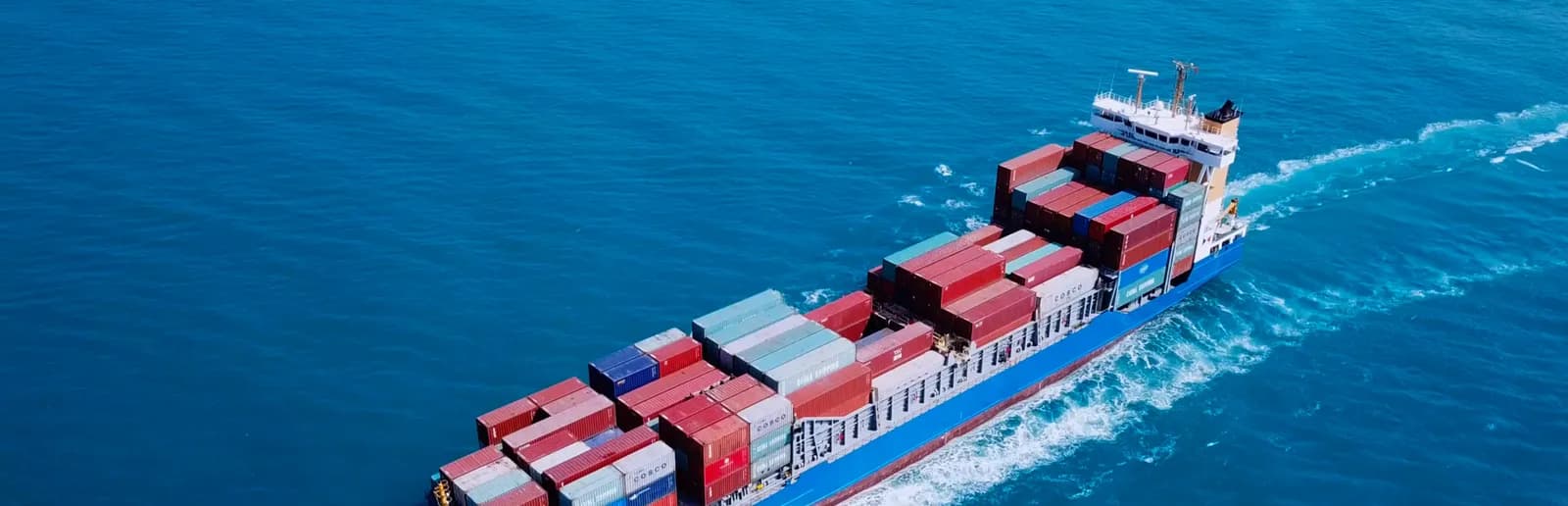 Aerial view of a loaded container ship under way on the open sea